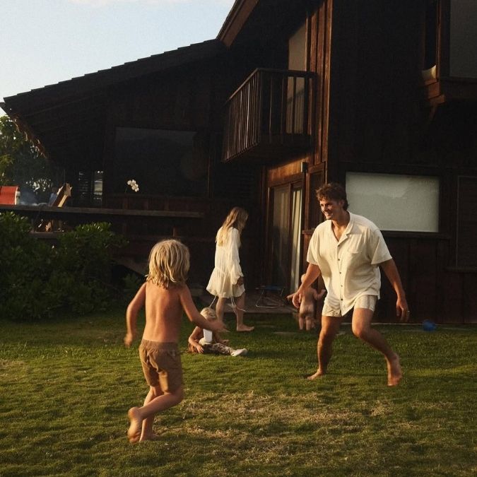 An Image of Forrest Frank Playing with his kids in backyard