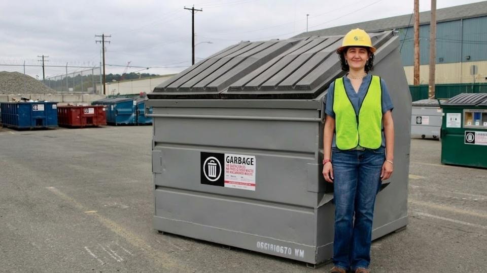 An Image of a 6-yard Dumpster with a Person for the Comparison in real life
